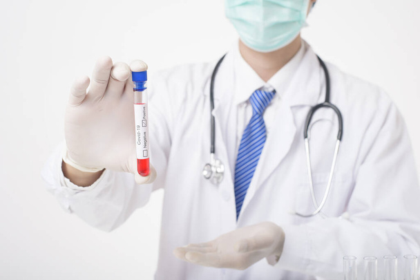 Doctor is holding infected  covid-19  blood test  on white Background  - Foto, Imagem