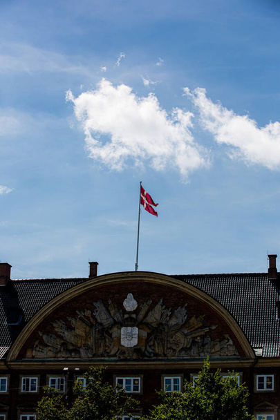 Danish flag in Copenhagen, Denmark on a clear summer day - Foto, imagen