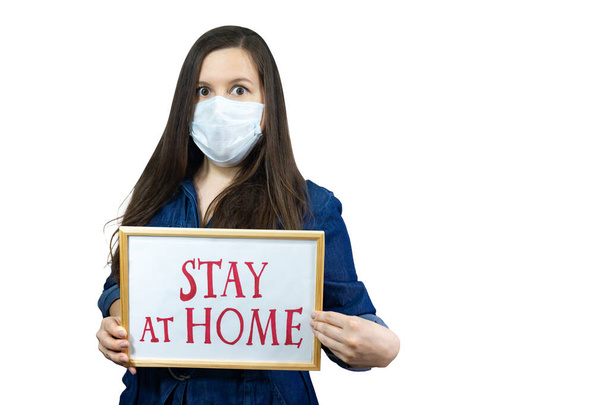 Woman holding sign Stay Home Save Lives global message coronavirus. Quarantine to fight COVID-19 pandemic. - 写真・画像