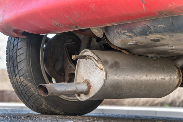 Car exhaust (muffler) fallen off a car - forgotten car on street concept - Photo, Image