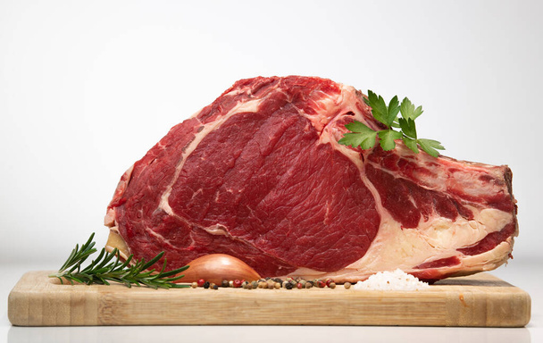 Raw T Bone steak on wooden board prepared to Grill  - Photo, Image