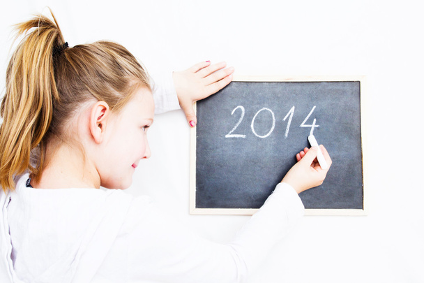 Little girl holding board with letters 2014. Happy new year - Photo, Image