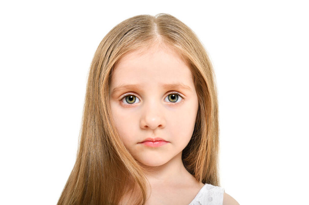 Portrait of a beautiful sad little girl, closeup, isolated on white background - Photo, Image