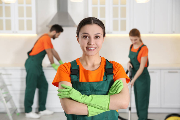 Professional janitor in uniform indoors. Cleaning service - Foto, Bild