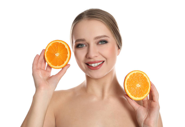 Young woman with cut orange on white background. Vitamin rich food - Fotografie, Obrázek