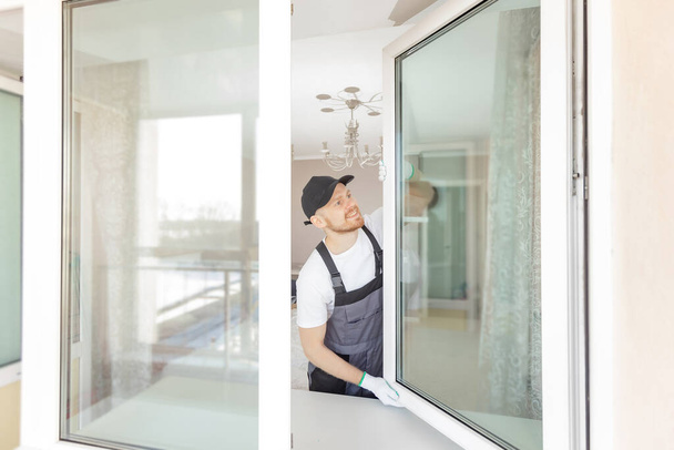 Travailleur dans l'installation de fenêtre en plastique blanc upvc sur la maison - Photo, image