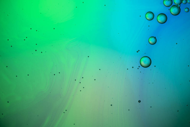 Abstract color background. Bubbles of oil in a colored liquid and lighting in macro photography. Creative and art concept - Photo, Image