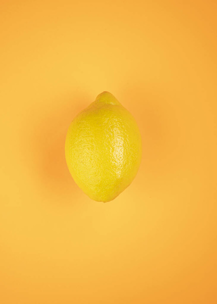 lemon, summer fruit, isolated on orange background - 写真・画像