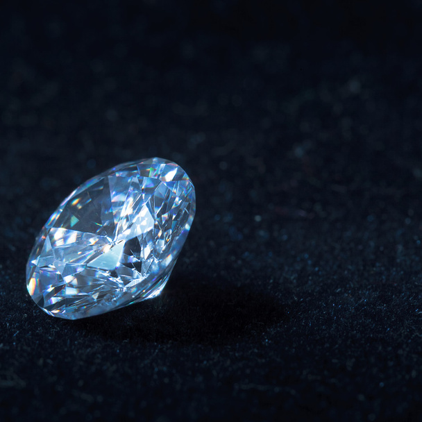 Blue diamond on black background with reflection - Foto, Imagem
