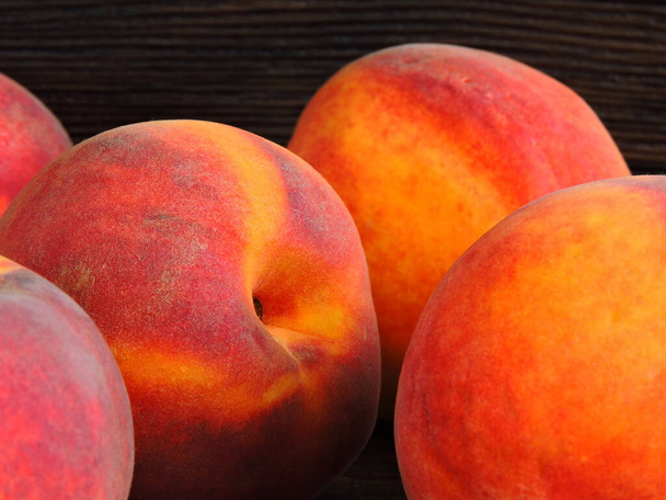 A bunch of peaches on a dark background. Copy space. - Photo, Image