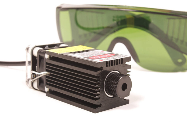 Safety green glasses for protection from laser radiation and high power laser isolated on the white background - Photo, Image