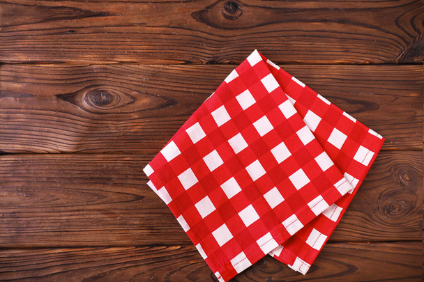 Rode servet op houten tafel - Foto, afbeelding