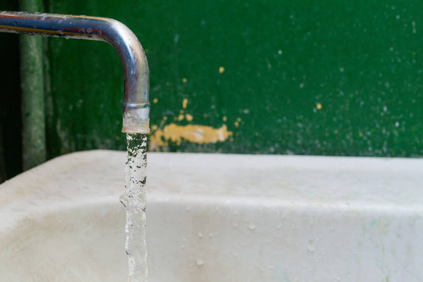 close-up view of old stained water tap with selective focus and background blur - Photo, Image