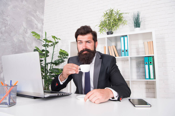 Who doesnt love drinking hot cup in morning. Engineer hold tea cup at work desk. Bearded man enjoy drinking coffee. Drinking hot beverage for energy. Healthy drinking habit. Morning and breakfast - 写真・画像