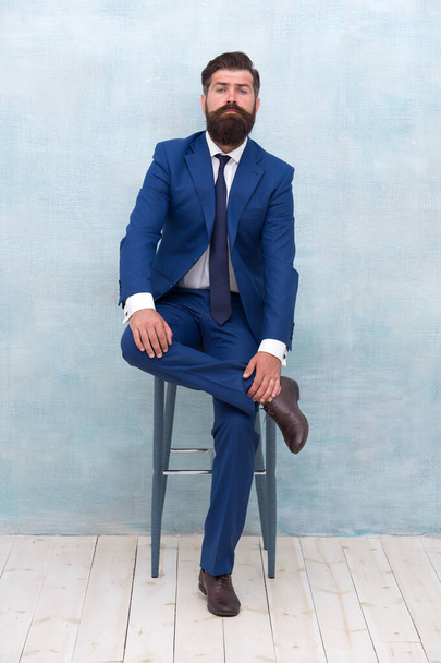 Sophisticated and classy. Confident businessman sit on chair. Fashion look of project manager. Formal fashion style. Formalwear. Mens wardrobe. Fashion store. Gorgeous and classic fashion - Foto, afbeelding