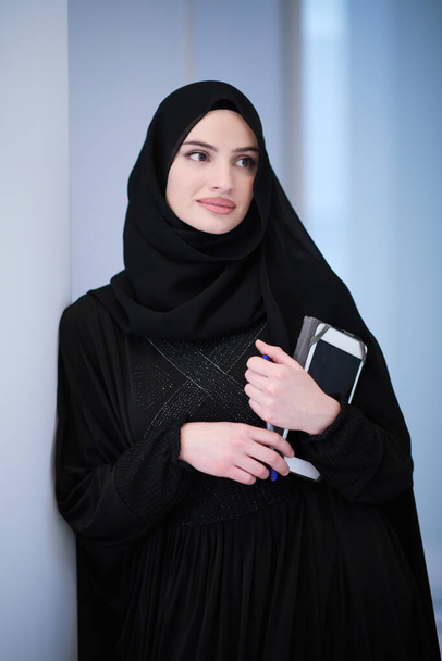 young modern muslim business woman holding tablet computer wearing hijab clothes at home - Фото, зображення