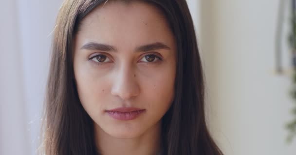 Portrait of serious confident young woman, looking at camera - Filmagem, Vídeo
