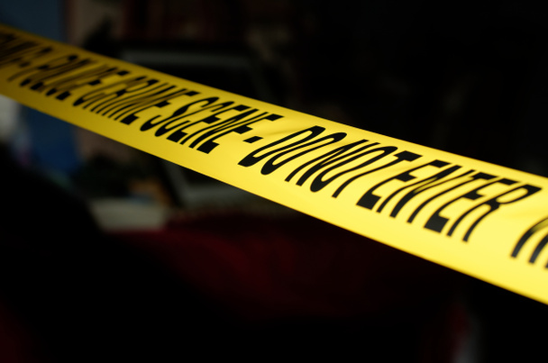 Yellow Police Crime Scene tape across a staged crime scene - Photo, Image