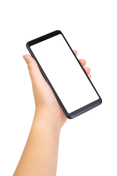 白い背景に白い画面が隔絶されたブラックスマートフォンを持つ女性の手。クリッピングパス - 写真・画像
