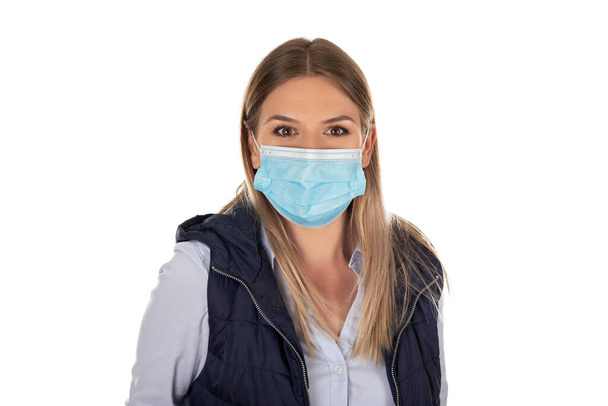 Beautiful caucasian woman wearing protective face mask , posing on isolated background - Photo, image