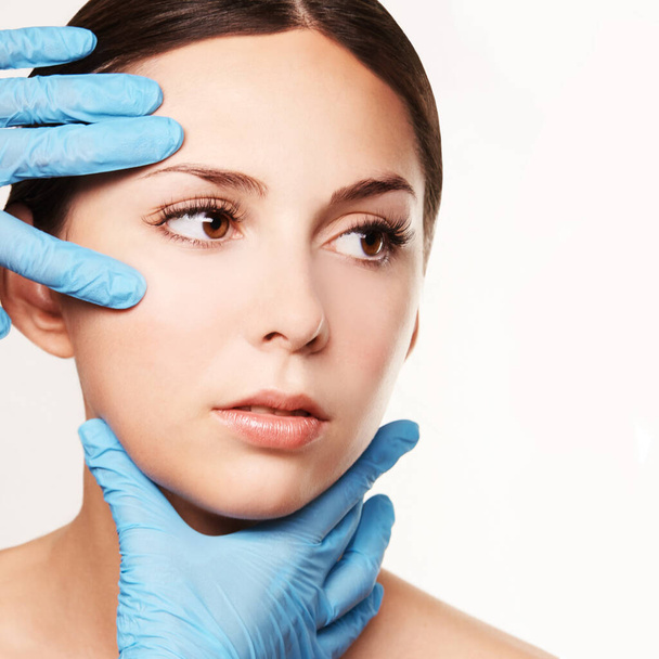 Facelift hydra treats. Esthetic skin care analysis. Doctor hands in gloves. - Фото, изображение