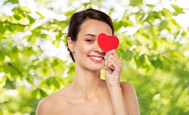 beautiful woman closing one eye with pink heart - 写真・画像