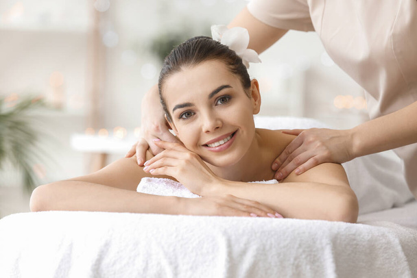 Beautiful young woman receiving massage in spa salon - Photo, image