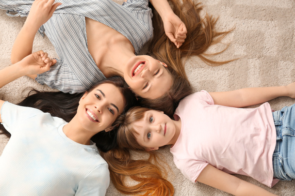 Happy lesbian couple with little adopted girl at home - Fotoğraf, Görsel