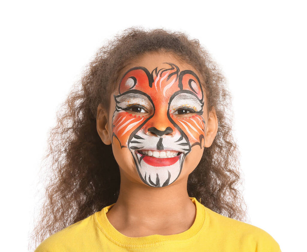 Funny African-American girl with face painting on white background - Photo, Image