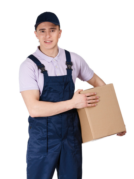 Workman in overalls hands a parcel - Φωτογραφία, εικόνα