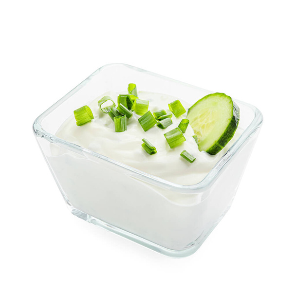 Delicious yogurt sauce with cucumber in bowl on white background - Valokuva, kuva