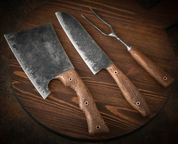Stylish Butcher's Set: cleaver, knife and fork. Top view. - 写真・画像