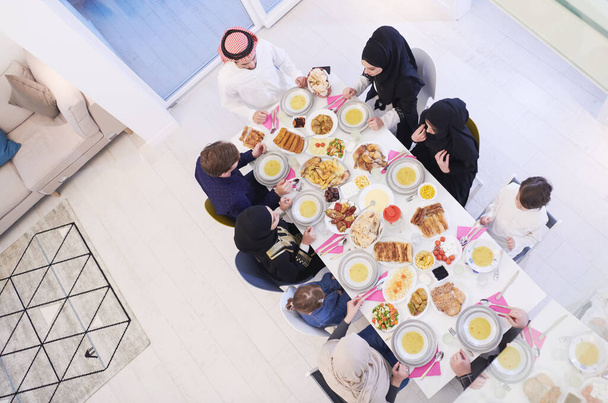 Eid Mubarak Muslim family having Iftar dinner  Eating traditional food during Ramadan feasting month at home. The Islamic Halal Eating and Drinking Islamic family top view - Fotografie, Obrázek