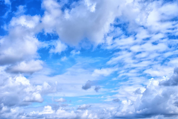 the bright blue cloudy sky in the summer midday - Photo, Image