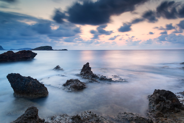 Stunning landscapedawn sunrise with rocky coastline and long exp - Photo, Image