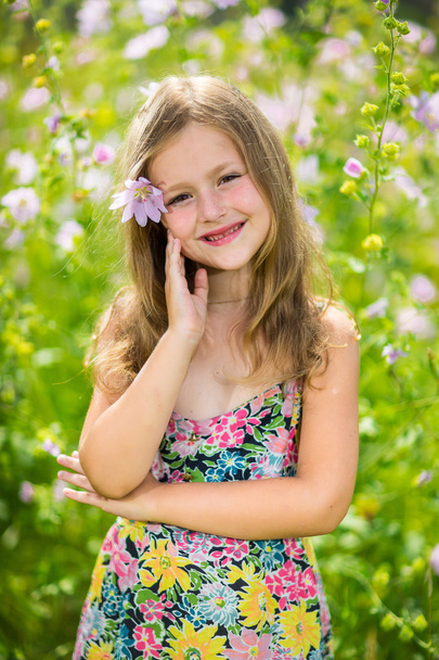 Portrait of a little girl in wreath of flowers - Photo, Image