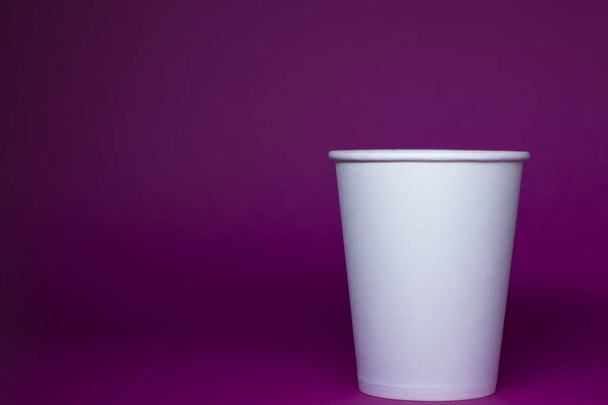 An empty white paper cup on a pink background. horizontal photo.  - Photo, Image