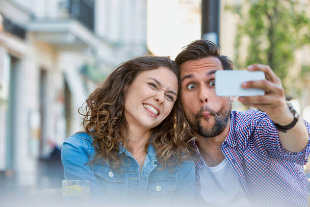 Portrait of man taking selfie with his beautiful girlfriend - Photo, Image