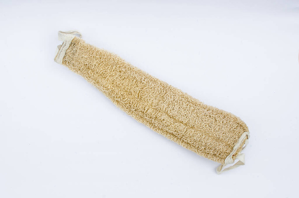 Luffa natural fiber sponge, dry Luffa for cleaning the body on a white background.Natural body washcloth on a white background - Φωτογραφία, εικόνα