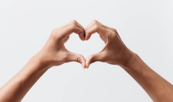 Man hands making a heart shape on a white isolated background - Foto, afbeelding