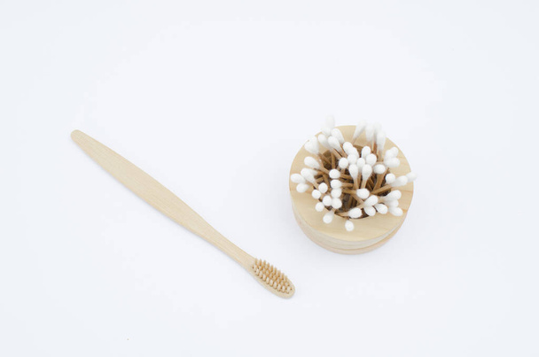 Toothbrush and ear sticks on a white background.Ecological product - absolutely safe clean environment.Zero waste concept. Eco-friendly materials.Set of personal care accessories. - 写真・画像