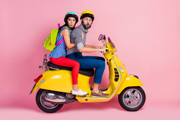 Profile side view of his he her she nice attractive cheerful cheery funny amazed couple driving moped spending vacation summer sport sale discount pout lips isolated over pink pastel color background - Foto, Imagen