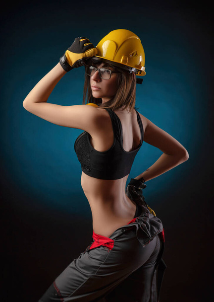 Girl in overalls with a chainsaw - Photo, Image
