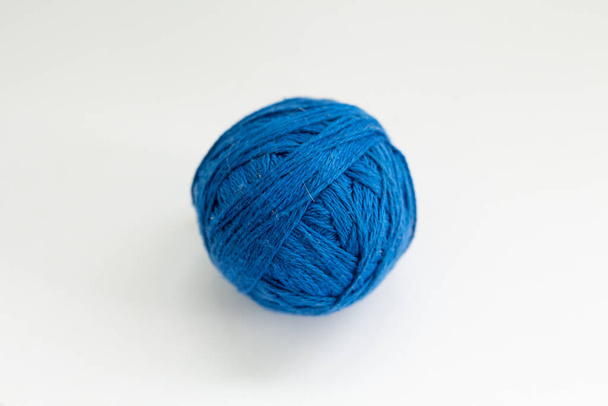 ball of blue thread on a white background - Foto, imagen