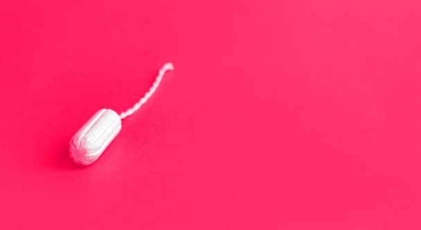 Protective white cotton tampon on pink background. - Fotografie, Obrázek