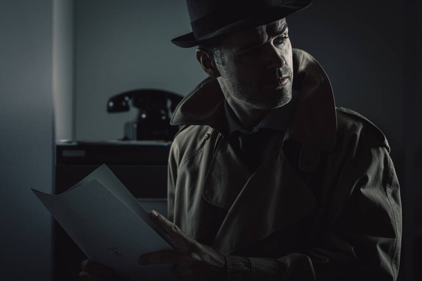 Vintage undercover agent stealing files in a corporate office late at night, security and data theft concept - Fotoğraf, Görsel