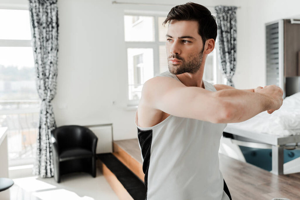 Handsome bearded man working out at home  - 写真・画像