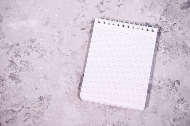 White blank sheet of notepad, on a gray background. Space for text, background. Template. - Фото, зображення