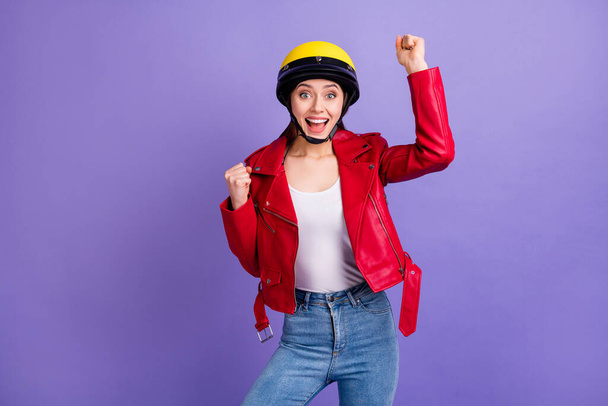 Portrait of astonished cheerful girl impressed lucky motor sport race competition win raise fists scream yeah wear denim isolated over purple color background - Foto, Imagem