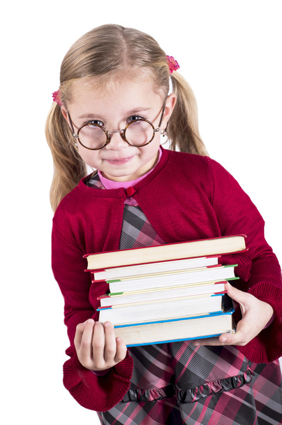 Ittle girl wearing spectacles holds books - Foto, afbeelding